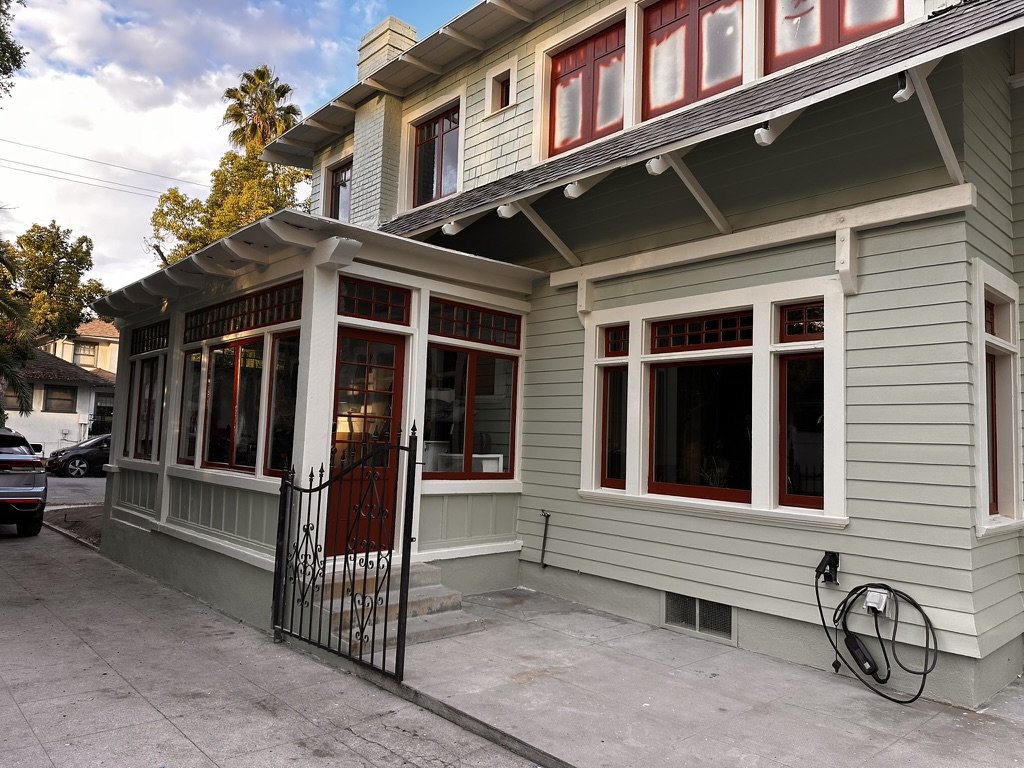 Restored sage green exterior with fresh trim