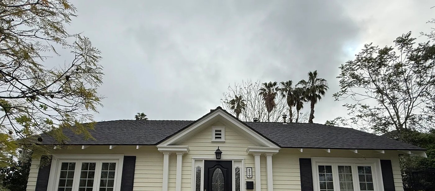 Cream traditional home with black shutters and columned entry, Pasadena